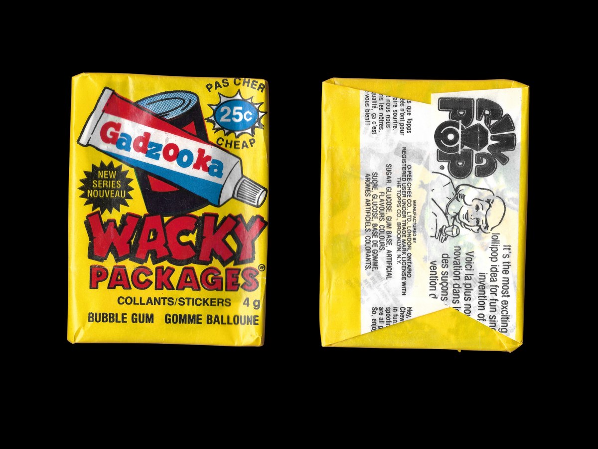 Front and back of a sealed 1989 OPC Wacky Packages wax pack featuring a Gadzooka sticker on the front. The yellow wrapper is intact, the wax is bright. The back of the wrapper shows OPC manufacturer information in English and French, plus a printed advertisement for OPC Ring Pop.