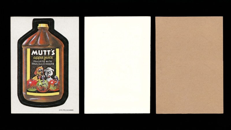 Three 1973 1st Series OPC Wacky Packages cards shown side by side — Mutt's Apple Juice front, a white-back card, and a tan-back card — illustrating the back colour variation within the series
