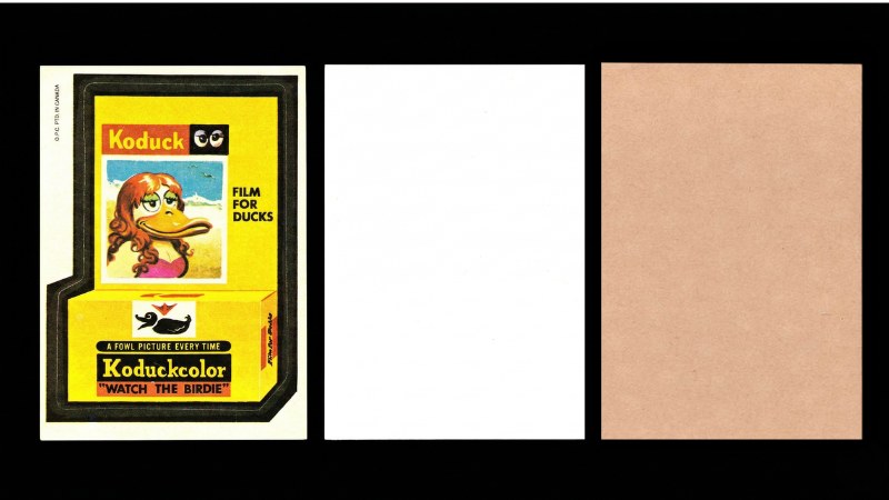 1973 OPC 3rd Series Koduck sticker showing front with vertical "O.P.C. PTD. IN CANADA" copyright on the left edge, white back, and tan back for comparison